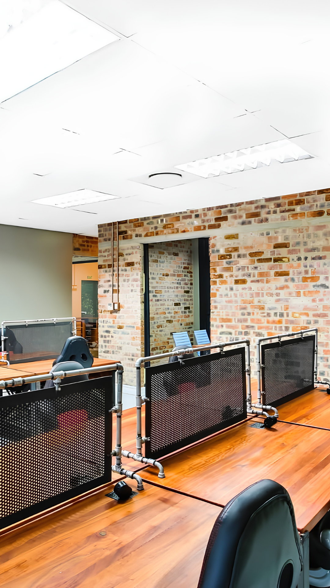 Commercial office fit-out with hardwood workstations and steel detailing